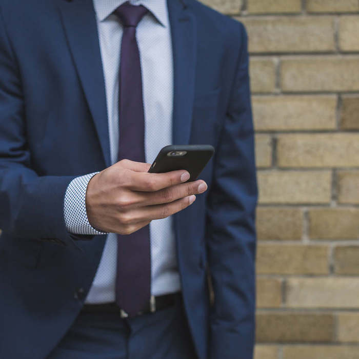 Large thumb businessman on smartphone