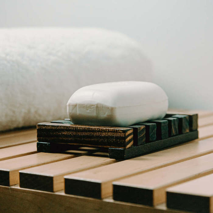 Large thumb bar of white soap on a wooden holder