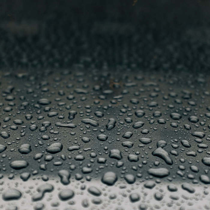 Large thumb rain drops on metal