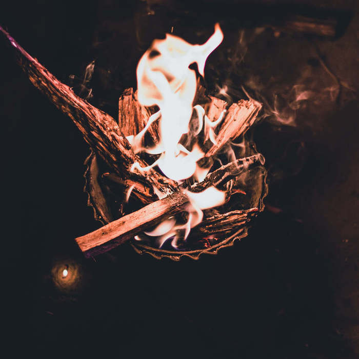 Large thumb a bowl of kindling set aflame